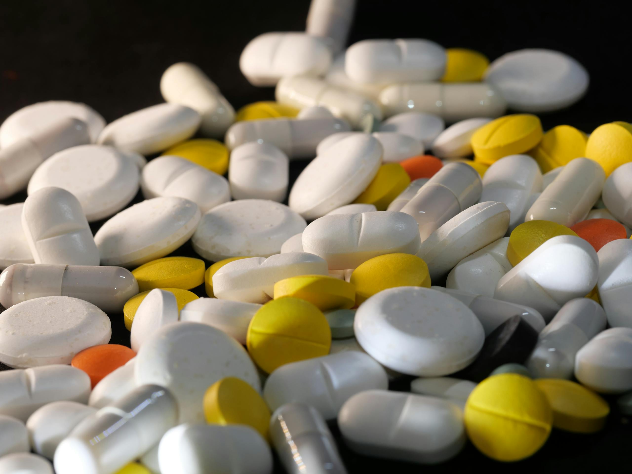 A close-up shot of various capsules and tablets, illustrating healthcare and medication concepts.