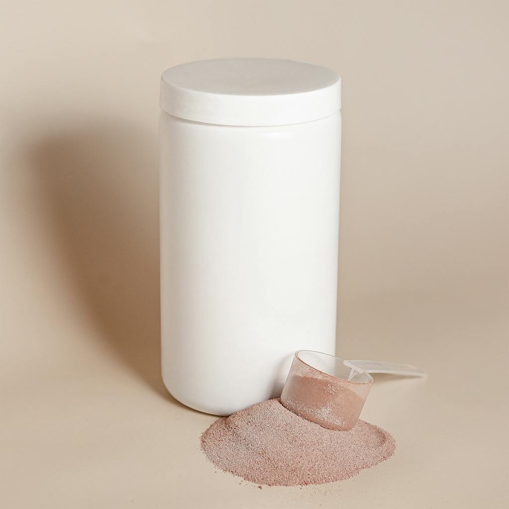 White container with protein powder and scoop on beige background.
